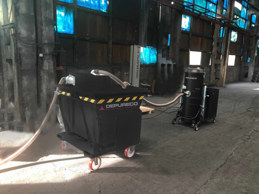 Depureco TX 400 high-power industrial vacuum connected to a large tiltable pre-separator cart inside a plant.