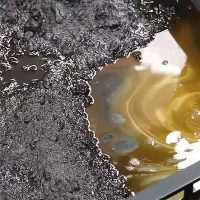 Depureco sump vacuum pipe removing oil and heavy sludge from CNC coolant tank.