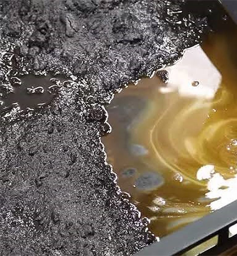 Depureco sump vacuum pipe removing oil and heavy sludge from CNC coolant tank.