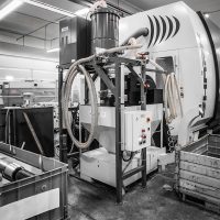 Stationary vacuum system in CNC machine shop.